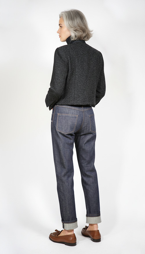 Model wearing Sewing Pattern Boxy Chanel Cut Jacket back view, made up in black Harris Tweed